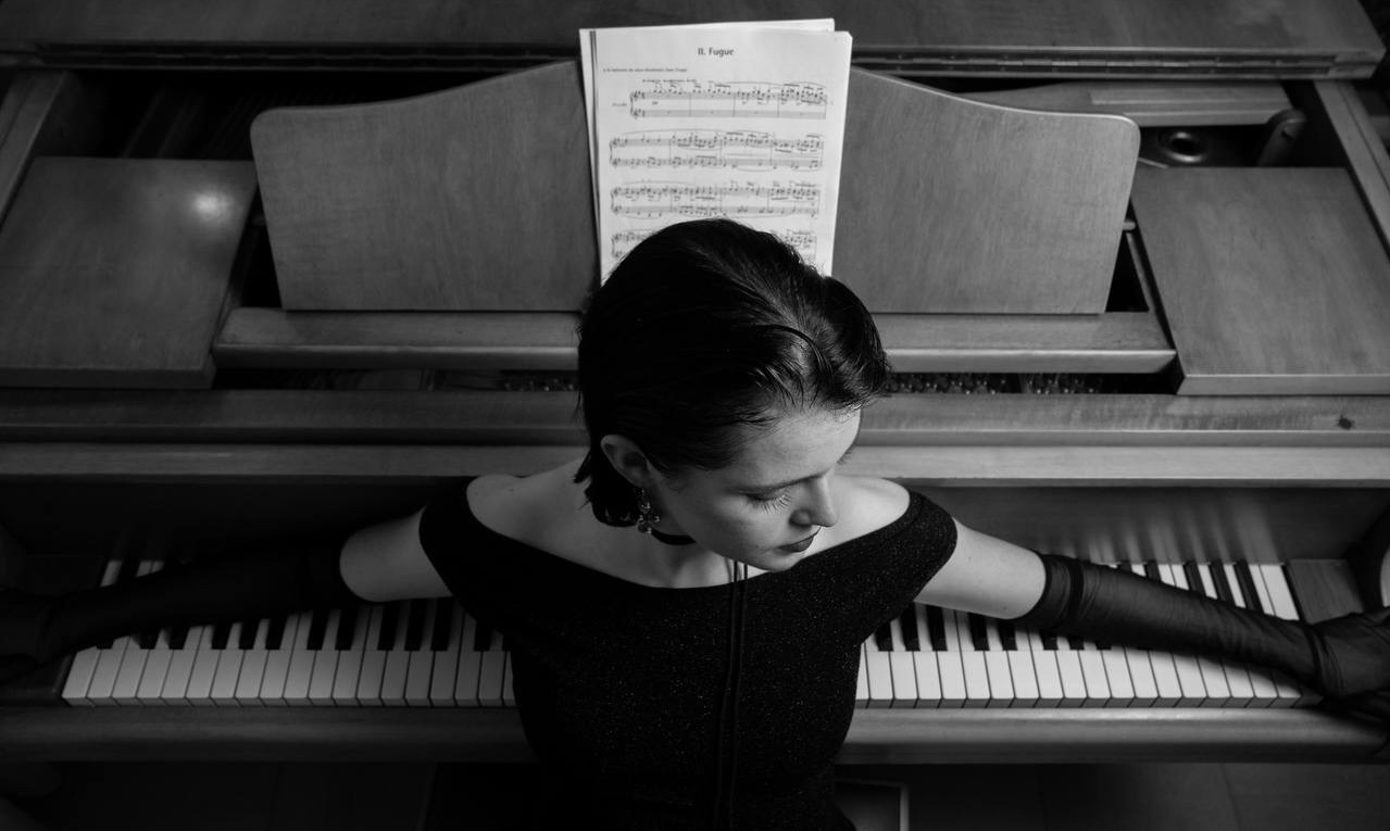 Julia bowing her head over the piano — the closing frame