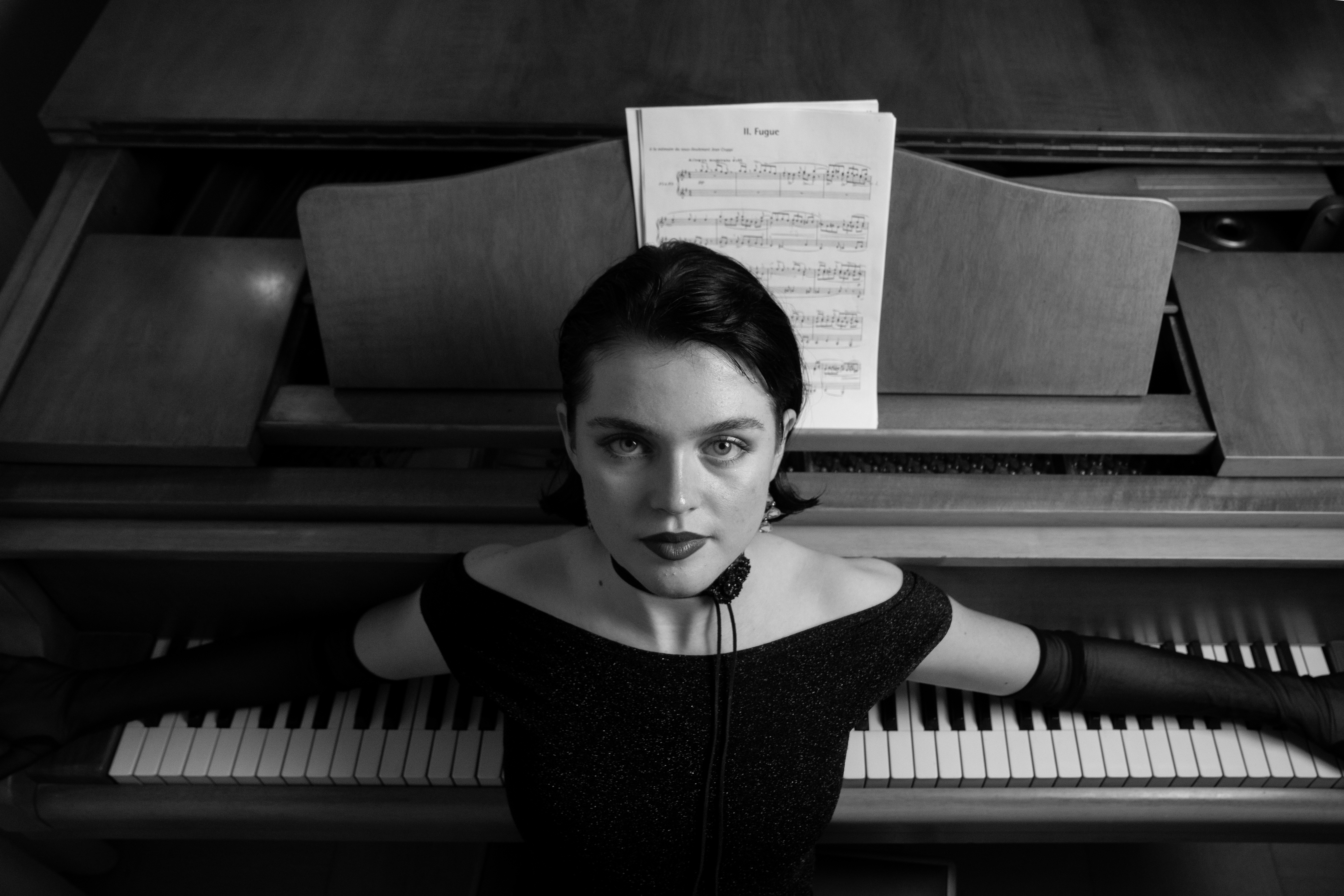 Julia looking into the camera over the keys
