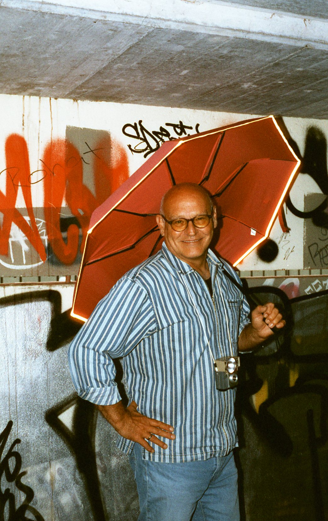 Photobooth frame — a stranger smiling under an umbrella
